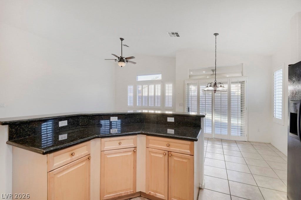 6729 Quarterhorse Lane, Las Vegas, NV 89148 Kitchen breakfast bar offers generous counter space with granite countertops, additional lower cabinetry and multiple electrical outlets, while overlooking the bright dining and great room areas with vaulted ceilings and plantation shutters.