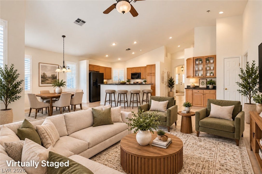 6729 Quarterhorse Lane, Las Vegas, NV 89148 An airy open layout connects the living area, kitchen, and dining space under high vaulted ceilings. *Virtually Staged*