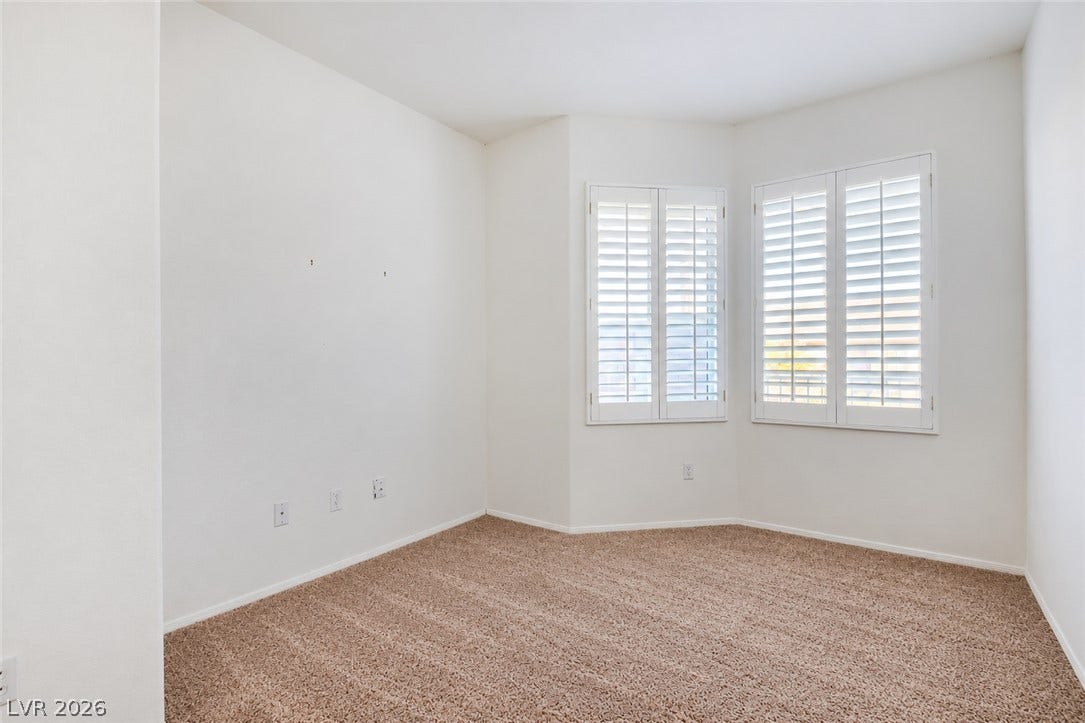 6729 Quarterhorse Lane, Las Vegas, NV 89148 Versatile office or flex space (12"x10") featuring carpet flooring, plantation shutters, abundant natural light, and a bay-style window area, ideal for a home office, den, hobby room, or additional sitting area.
