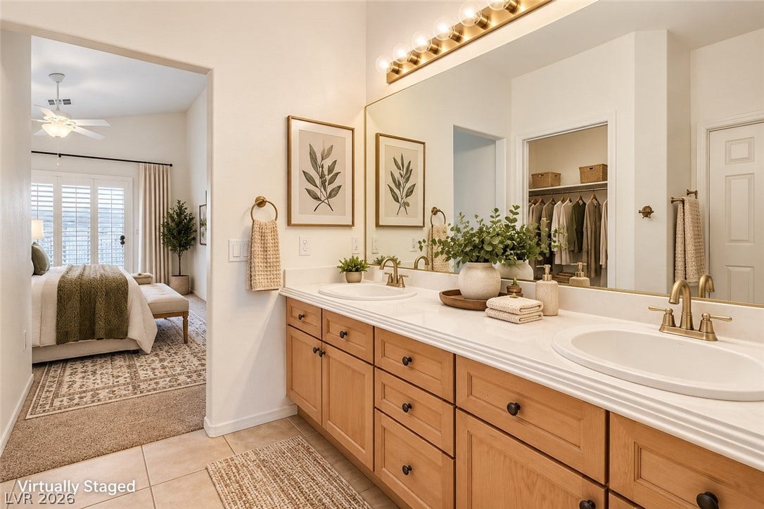 6729 Quarterhorse Lane, Las Vegas, NV 89148 A spacious vanity with dual sinks connects seamlessly to the carpeted primary suite. *Virtually Staged*