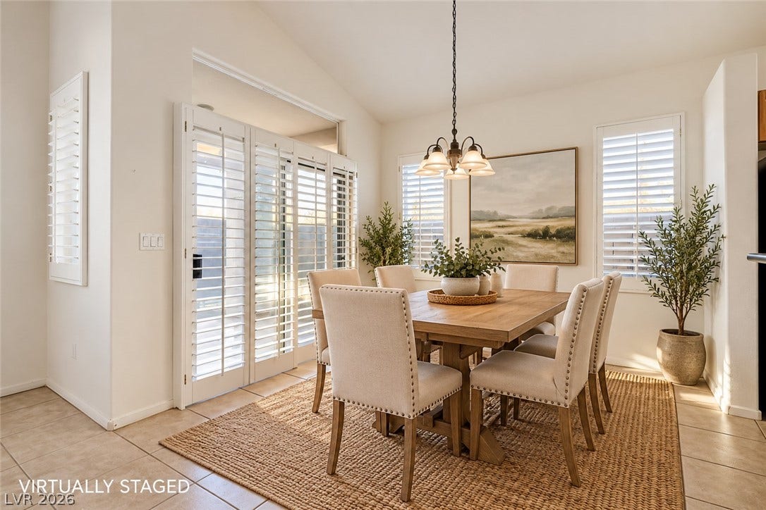 6729 Quarterhorse Lane, Las Vegas, NV 89148 Vaulted ceilings and warm tile flooring create an inviting atmosphere in this dining room. *Virtually Staged*