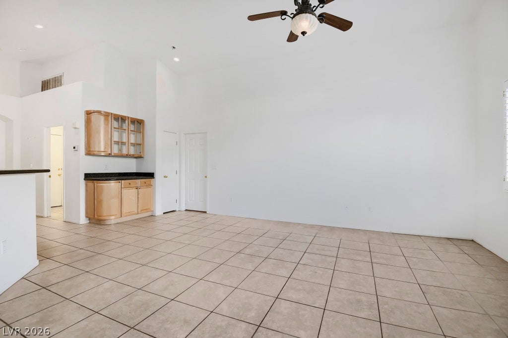 6729 Quarterhorse Lane, Las Vegas, NV 89148 Spacious great room featuring vaulted ceilings, neutral tile flooring, ceiling fan with light fixture, recessed lighting, and an open layout offering plenty of flexibility for living and entertaining.