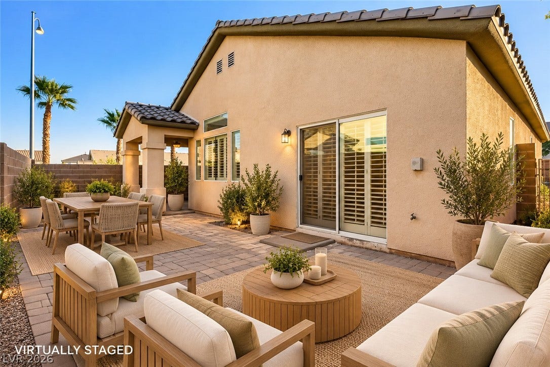 6729 Quarterhorse Lane, Las Vegas, NV 89148 A spacious stone paver patio offers an ideal setting for relaxed outdoor living. *Virtually Staged*