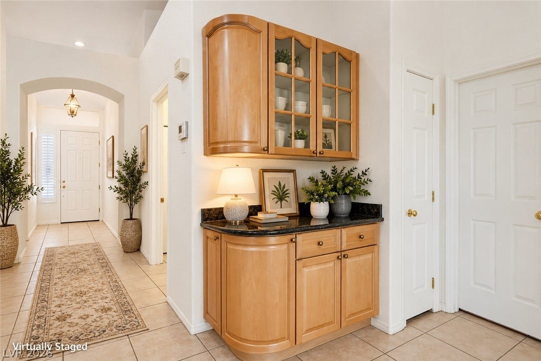 6729 Quarterhorse Lane, Las Vegas, NV 89148 An arched doorway leads into a tiled hallway bordered by a built-in buffet niche. *Virtually Staged*