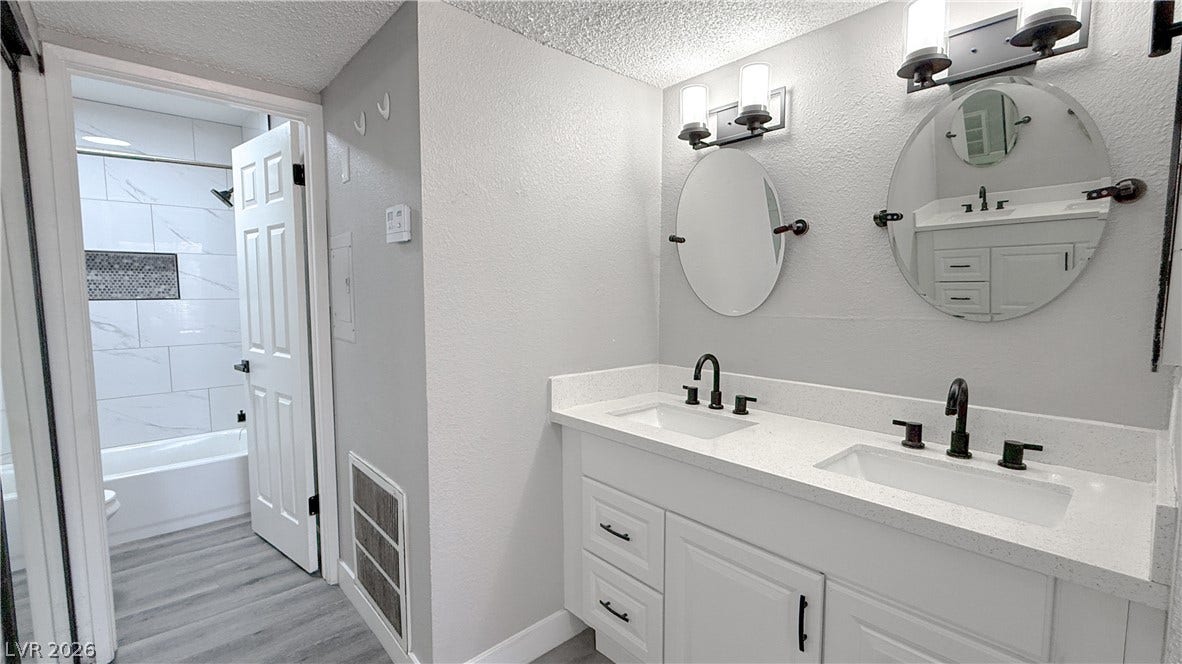 4321 Gannet Circle, #199, Las Vegas, NV 89103 Dual sinks set in quartz counters elevate this modern bathroom layout.