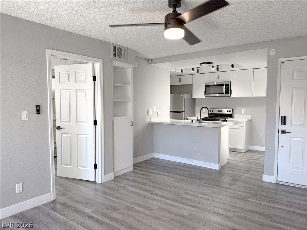 4321 Gannet Circle, #199, Las Vegas, NV 89103 Luxury vinyl plank floors and a modern open kitchen create an inviting interior environment.
