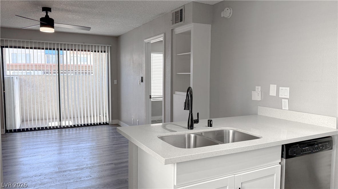 4321 Gannet Circle, #199, Las Vegas, NV 89103 An open kitchen counter overlooks the main living space detailed with modern plank flooring.