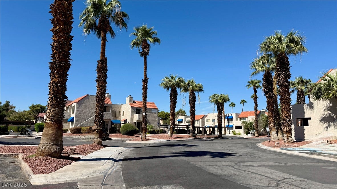 4321 Gannet Circle, #199, Las Vegas, NV 89103 Towering palm trees frame the quiet paved street of this desert-style residential community.