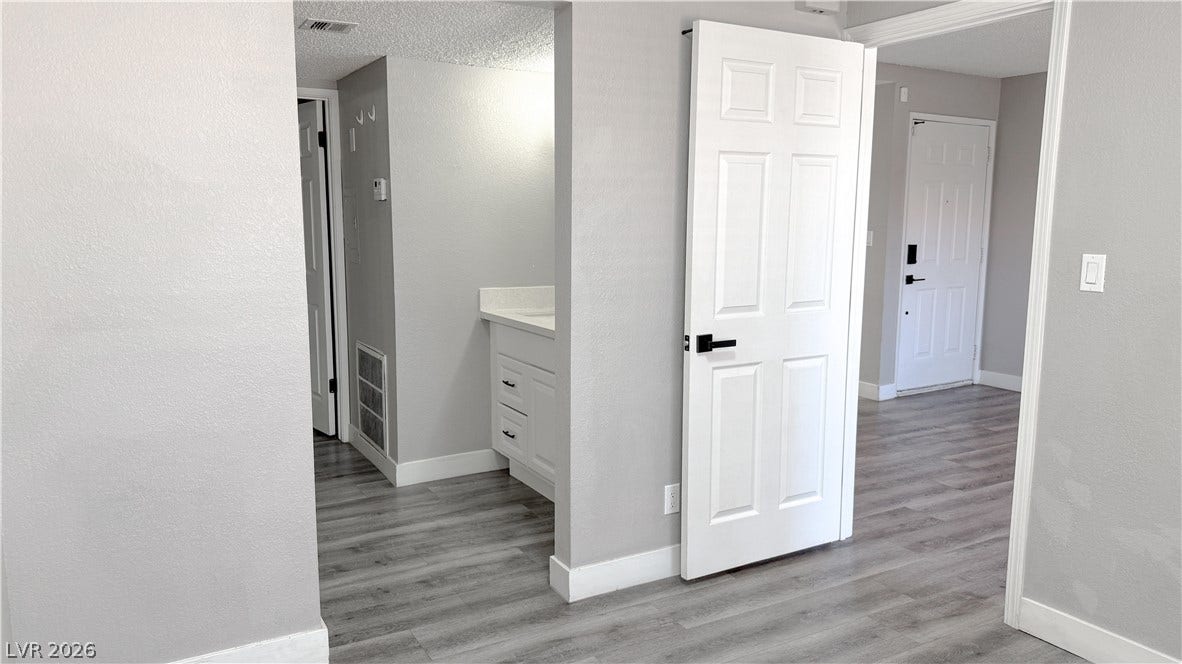 4321 Gannet Circle, #199, Las Vegas, NV 89103 Streamlined transitions connect the neutral-toned hallways to a convenient vanity nook and living areas.