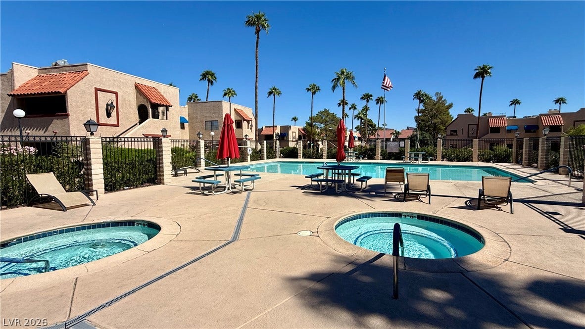 4321 Gannet Circle, #199, Las Vegas, NV 89103 Palm trees surround a spacious outdoor pool and spa area featuring tile accents.