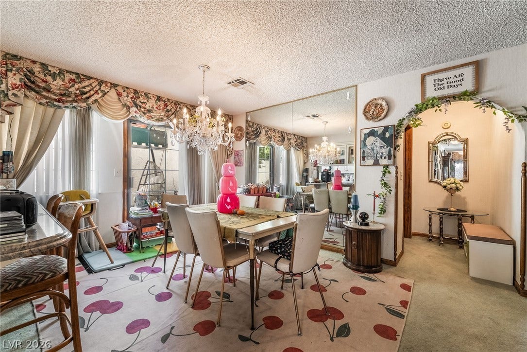 An arched doorway and mirrored accent wall define this classic dining space.