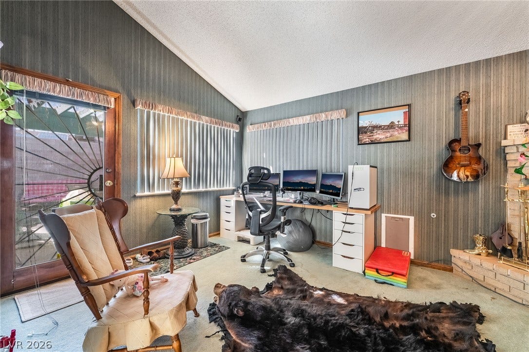 Vaulted ceilings and a brick fireplace create an inviting atmosphere in this versatile space.