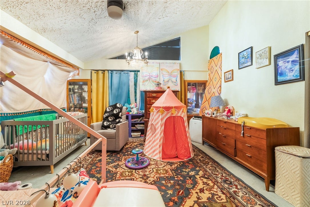 Vaulted ceilings and unique window placements highlight the architectural personality of this bedroom.