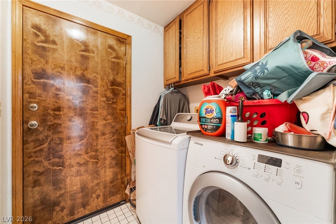 Oak cabinetry and tile flooring define this functional utility space.