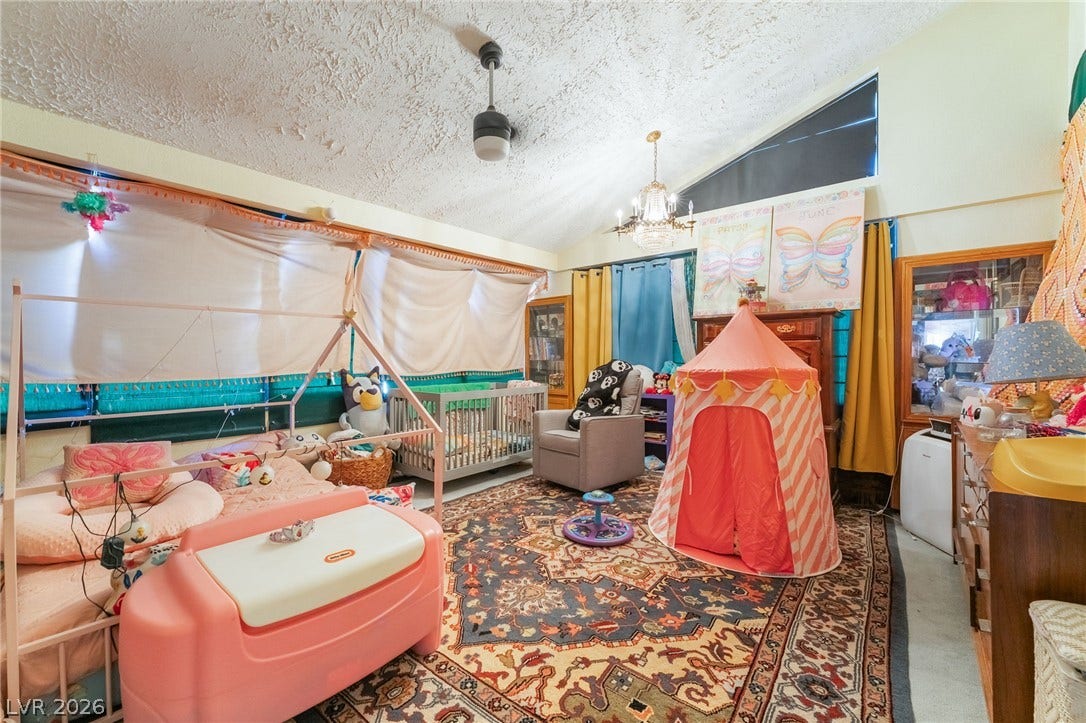Vaulted ceilings and wood-framed display windows highlight this versatile bedroom space.