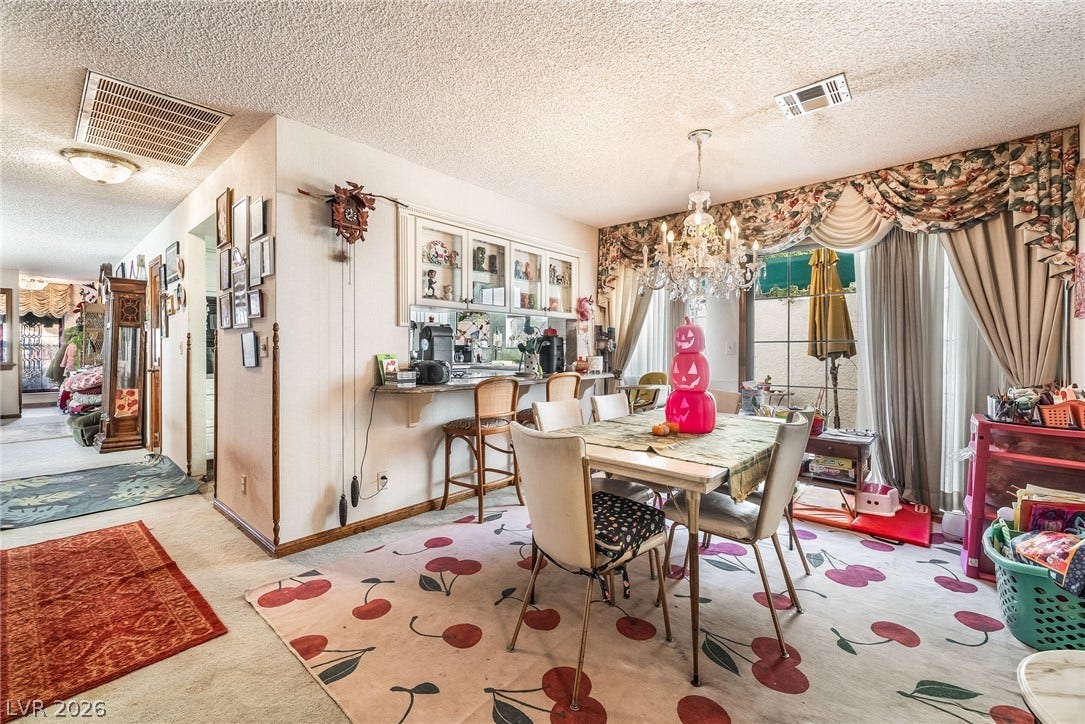 An open dining area flows into adjacent spaces with carpeted flooring throughout.