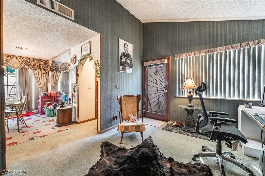 Vaulted ceilings and textured wall treatments define this versatile office space.