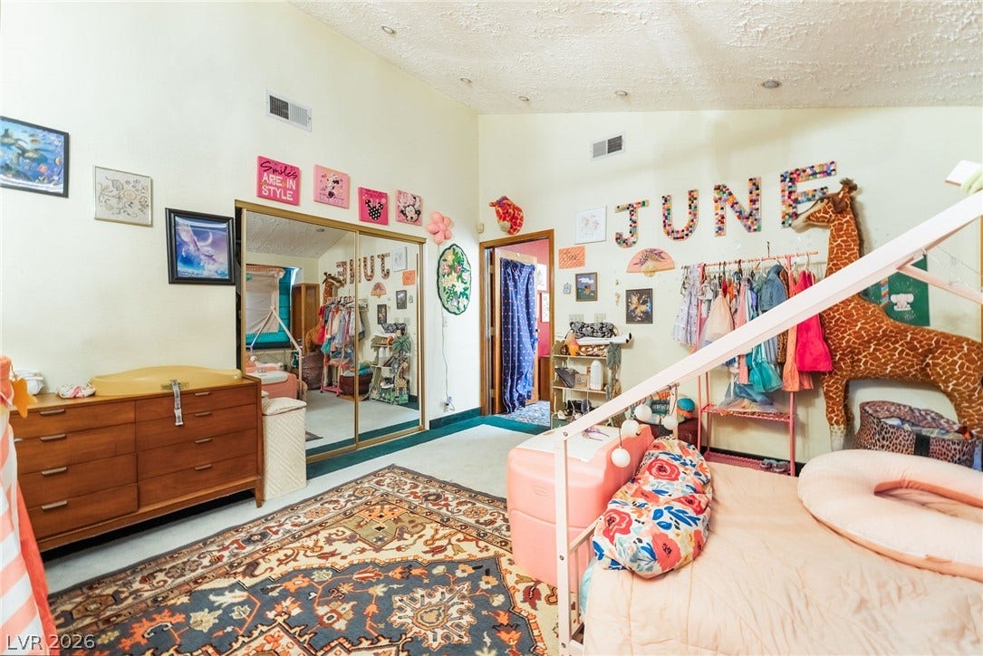 Slanted ceilings and mirrored closet doors maximize the sense of space in this bedroom.