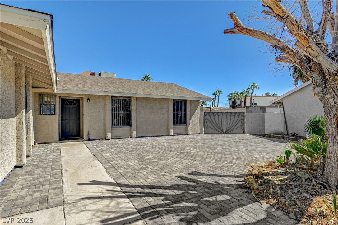 4442 Eureka Circle, Las Vegas, NV 89103 An expansive interlocking paver driveway sweeps across the front of this single-story residence.