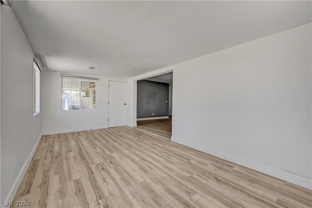 4442 Eureka Circle, Las Vegas, NV 89103 Smooth wood floors flow seamlessly through this wide doorway into the adjacent living space.