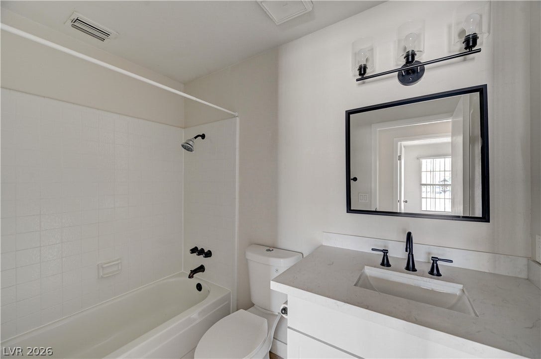 4442 Eureka Circle, Las Vegas, NV 89103 Crisp finishes and a modern vanity highlight this clean bathroom design.