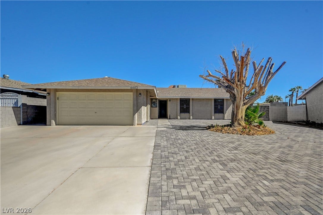 4442 Eureka Circle, Las Vegas, NV 89103 A spacious driveway and neat paver courtyard lead to this single-story desert home.