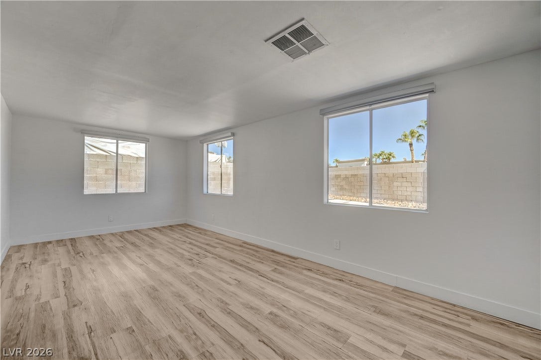 4442 Eureka Circle, Las Vegas, NV 89103 Smooth wood-plank flooring runs throughout this versatile space illuminated by multiple windows.