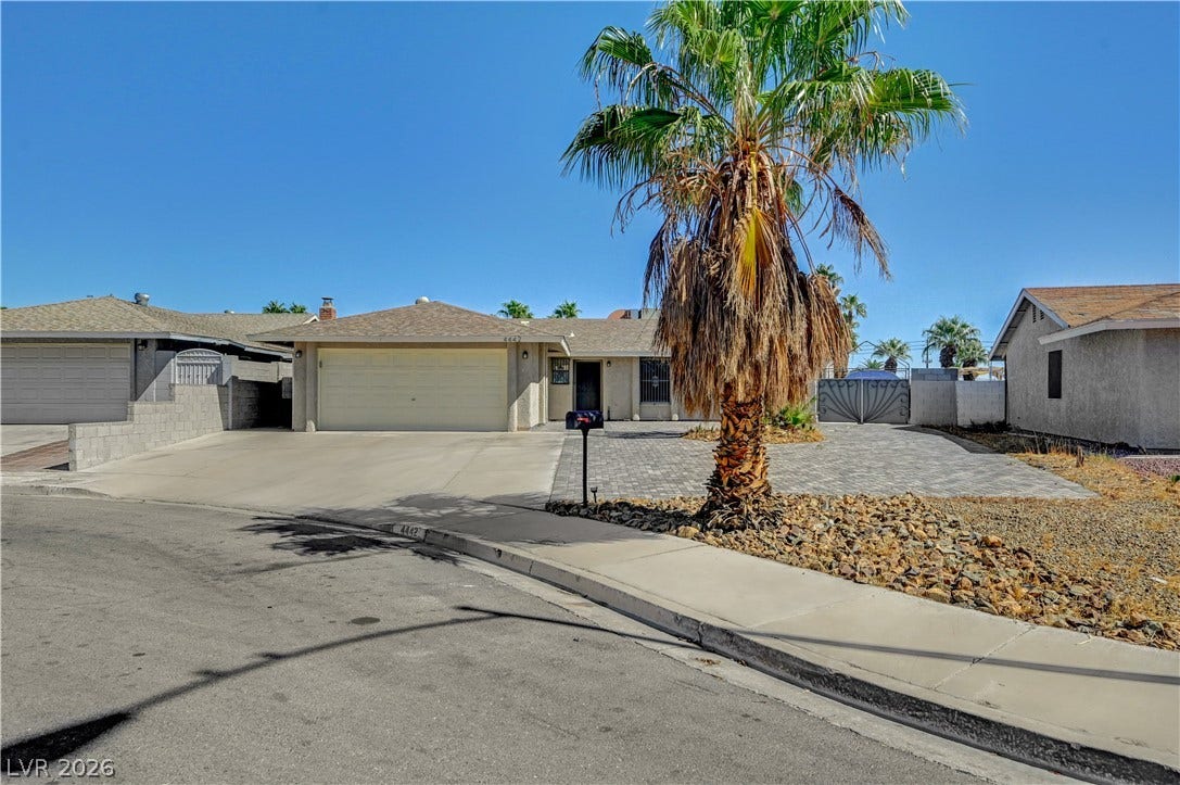 4442 Eureka Circle, Las Vegas, NV 89103 A classic single-story exterior features a spacious driveway alongside neat desert landscaping.