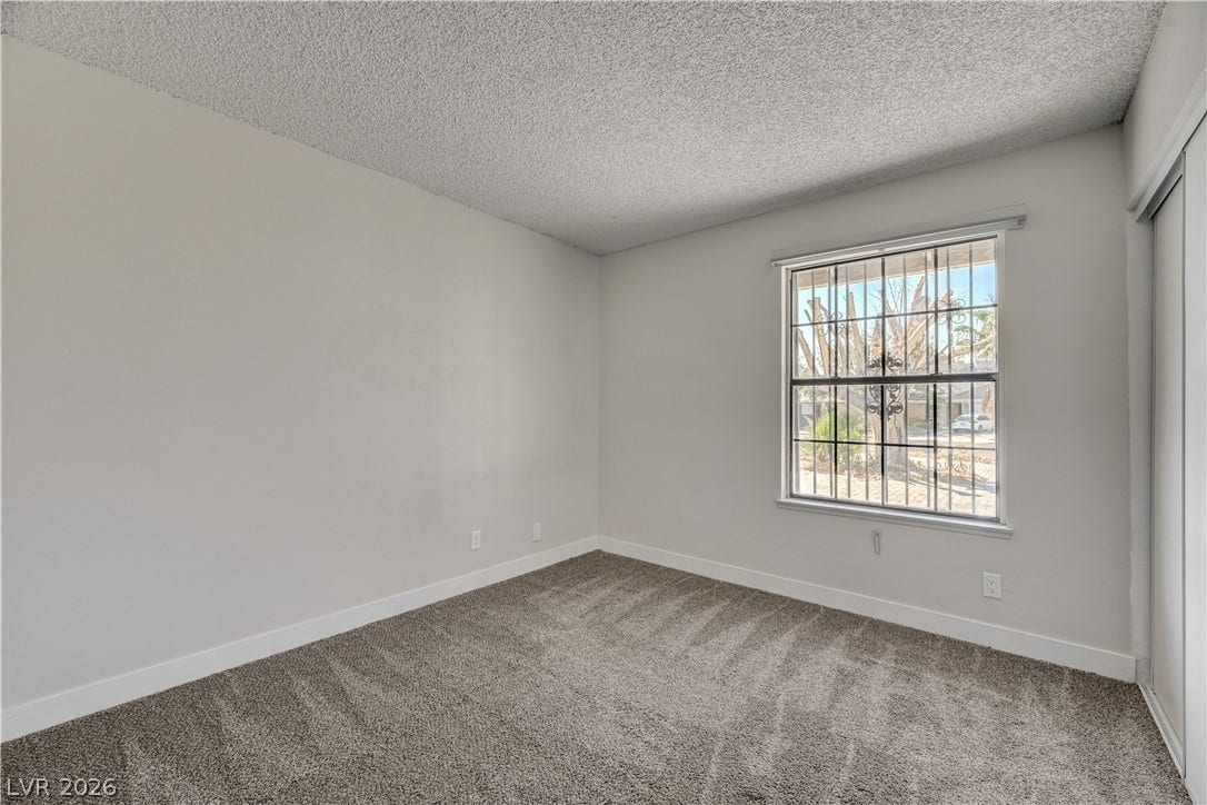 4442 Eureka Circle, Las Vegas, NV 89103 Plush carpeting and textured ceilings define this clean, adaptable secondary bedroom space.