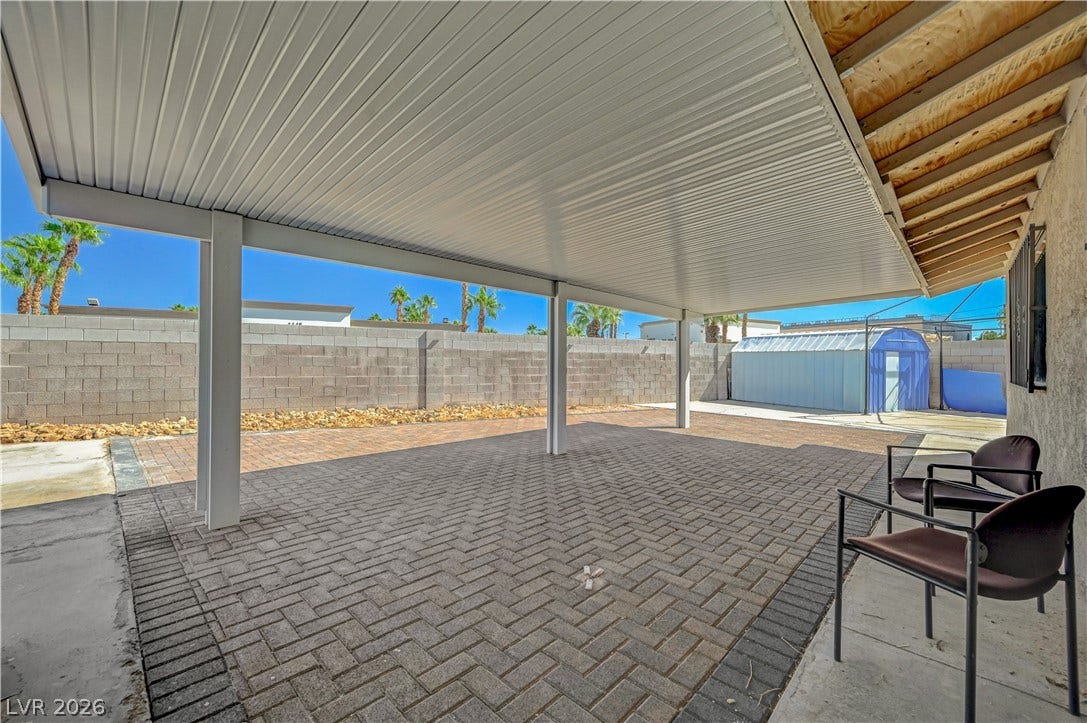4442 Eureka Circle, Las Vegas, NV 89103 A spacious covered patio with block pavers overlooks the enclosed rear yard.