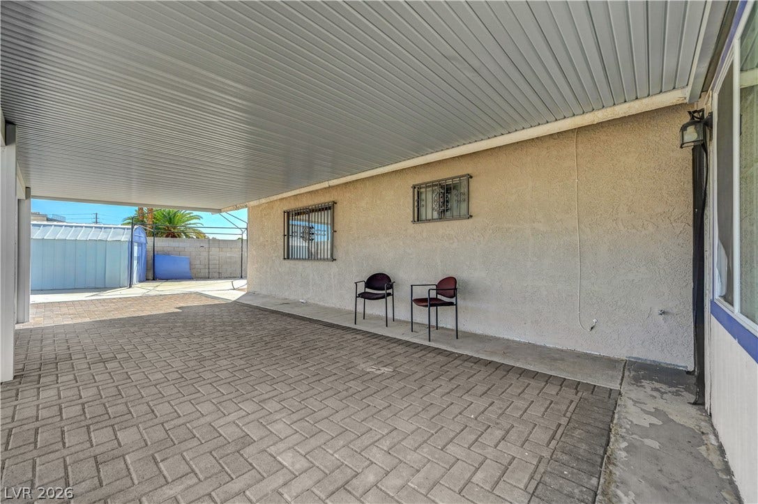 4442 Eureka Circle, Las Vegas, NV 89103 A spacious covered carport features durable paver block flooring and clean stucco walls.