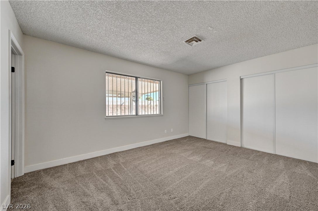 4442 Eureka Circle, Las Vegas, NV 89103 Plush carpeting and dual sliding closets ground this versatile space.