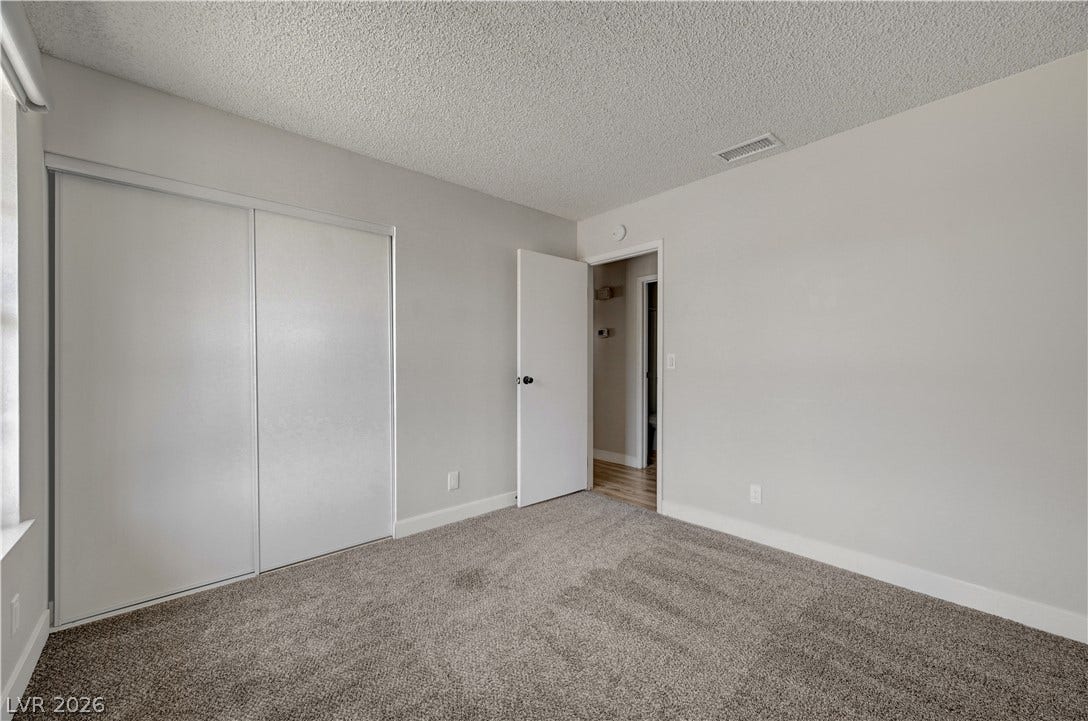 4442 Eureka Circle, Las Vegas, NV 89103 Plush carpeting and large sliding closet doors define this functional bedroom space.