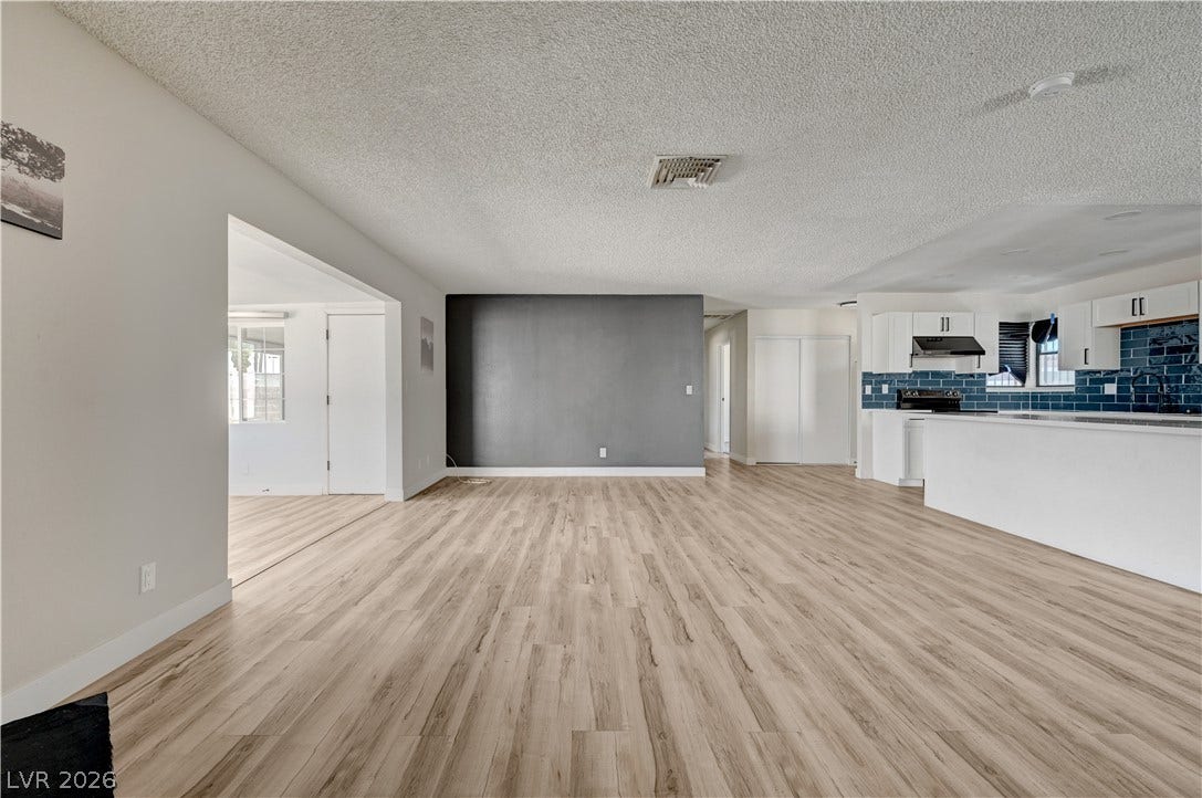 4442 Eureka Circle, Las Vegas, NV 89103 Smooth wood-style flooring anchors this versatile open layout seamlessly connecting to the kitchen.