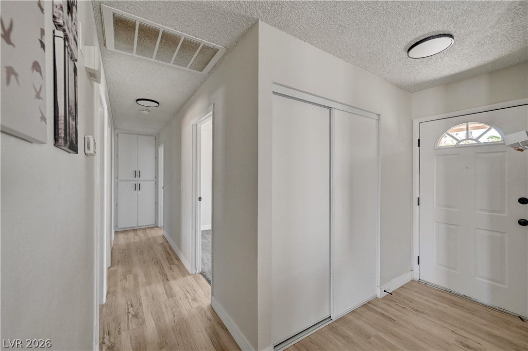4442 Eureka Circle, Las Vegas, NV 89103 An inviting entryway transitions smoothly into a hallway with wood-look flooring and built-in storage.