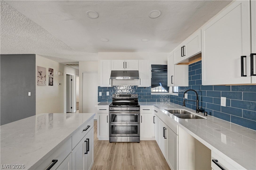 4442 Eureka Circle, Las Vegas, NV 89103 Gleaming stone countertops and sleek cabinetry define this contemporary culinary workspace.