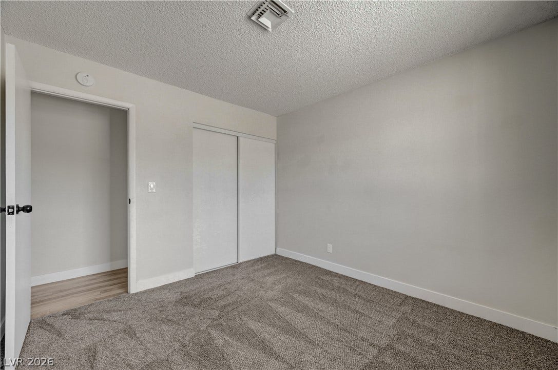 4442 Eureka Circle, Las Vegas, NV 89103 Plush carpeting anchors this versatile room featuring clean walls and sliding closet doors.