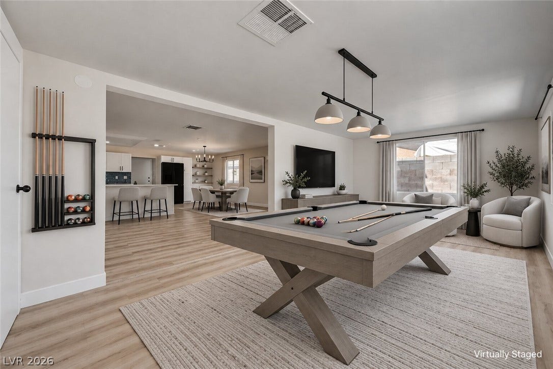4442 Eureka Circle, Las Vegas, NV 89103 An open floorplan seamlessly connects the versatile game room with the kitchen and dining areas.