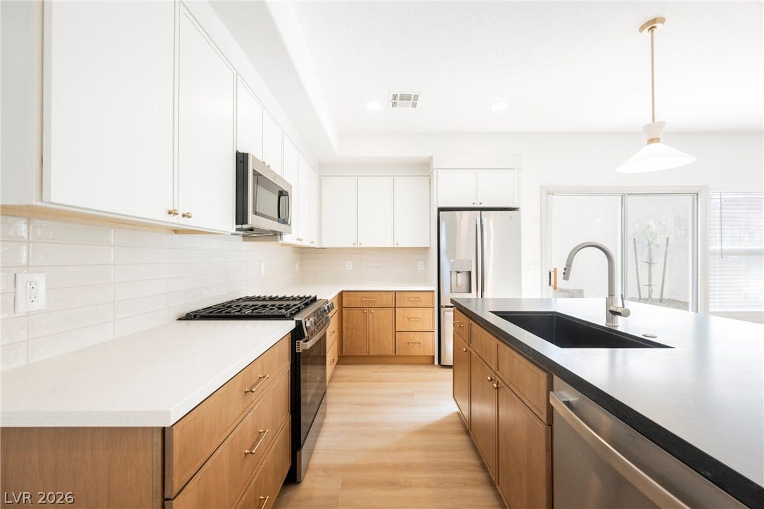 Clean lines and modern design define this well-appointed kitchen featuring a functional prep island.