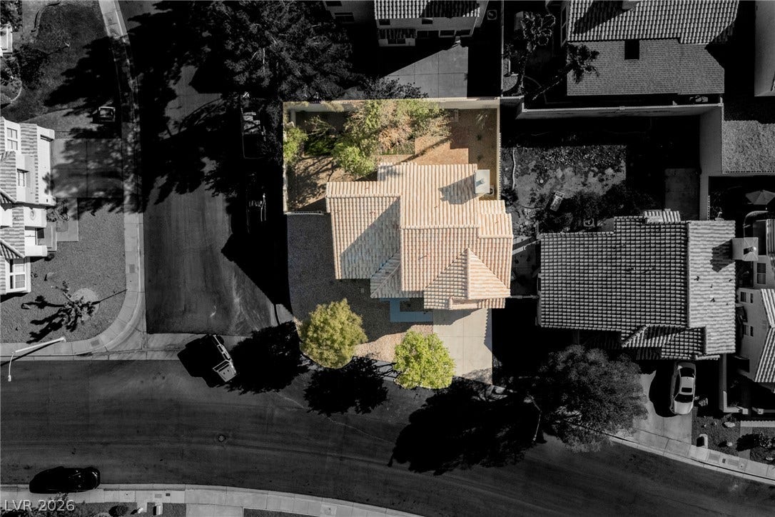An aerial perspective captures the tiled roofline and surrounding neighborhood of this property.