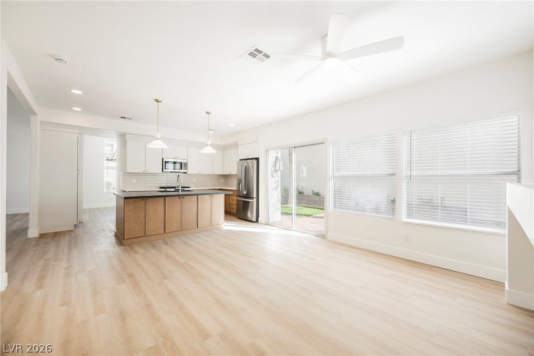 Gleaming wood floors anchor an airy open concept living space and kitchen.