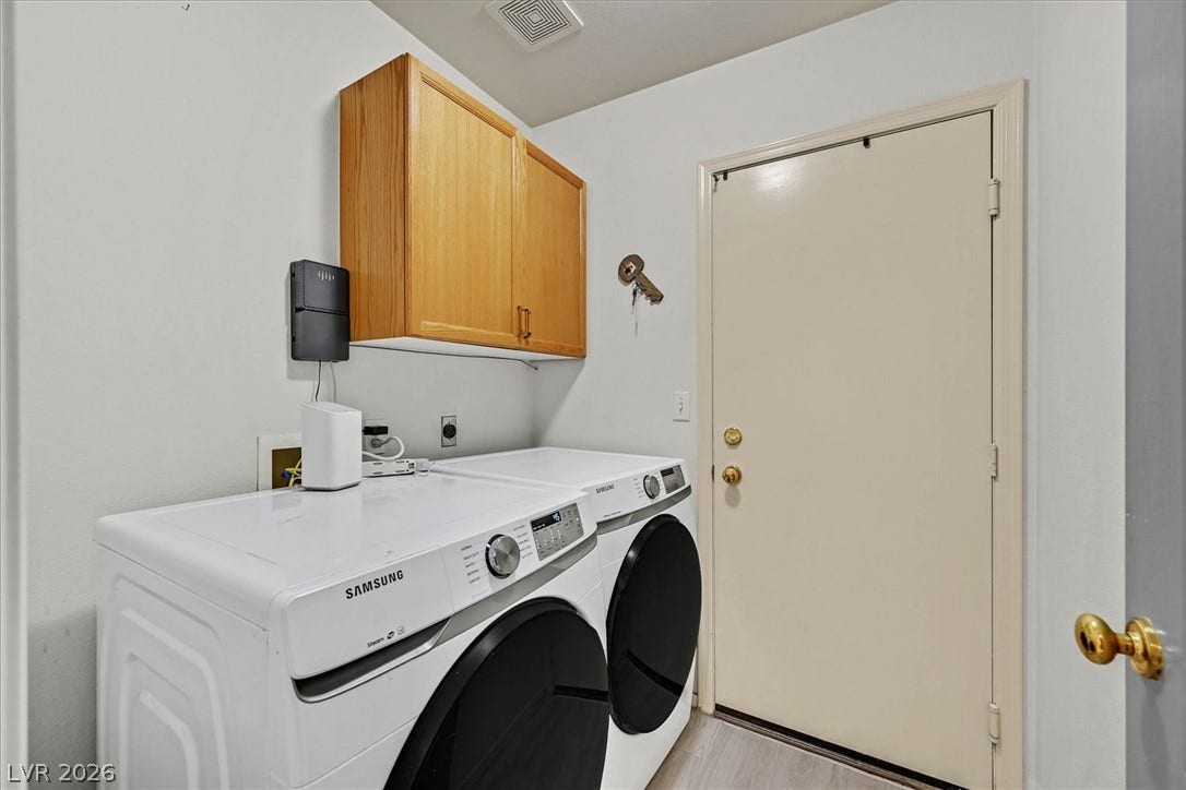 8830 Haviland Road, Las Vegas, NV 89123 A dedicated laundry space features overhead wood cabinetry and direct exterior access.