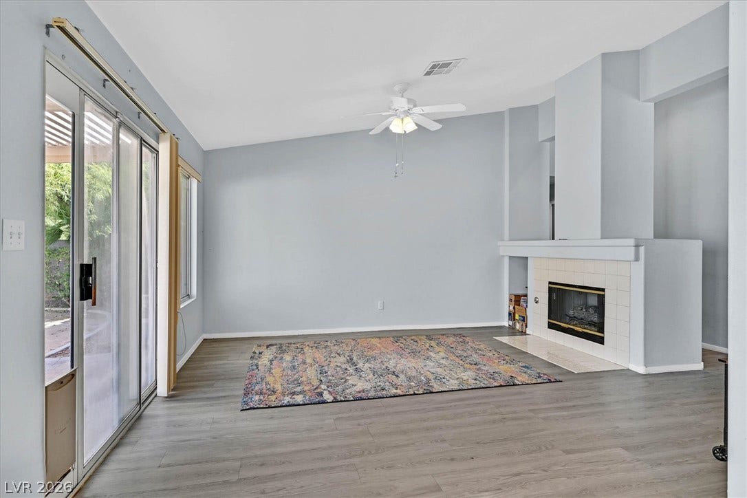 8830 Haviland Road, Las Vegas, NV 89123 A wood-look floor pairs beautifully with a modern fireplace and sliding glass doors.