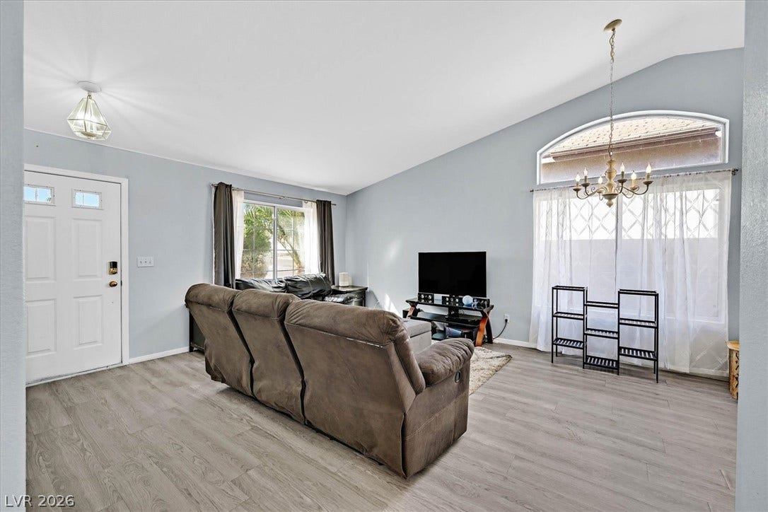 8830 Haviland Road, Las Vegas, NV 89123 Vaulted ceilings and wide-plank flooring define this inviting living area.