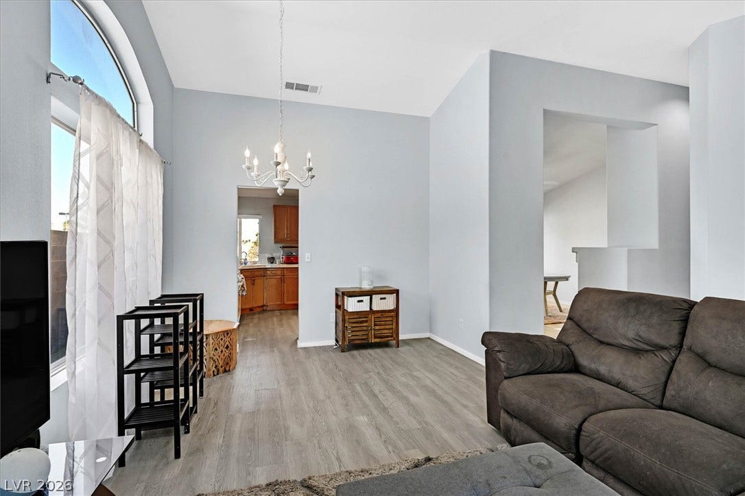 8830 Haviland Road, Las Vegas, NV 89123 High vaulted ceilings and wood-style flooring elevate this comfortable living space.