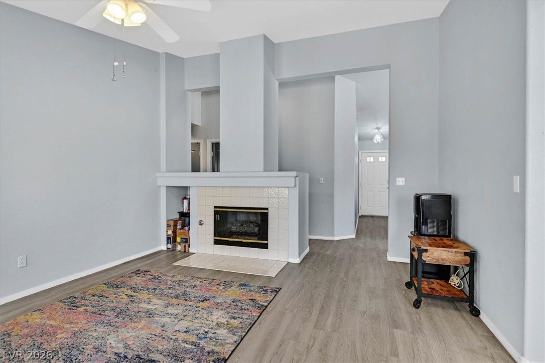 8830 Haviland Road, Las Vegas, NV 89123 A tiled fireplace anchors this comfortable living space finished with durable wood-look flooring.