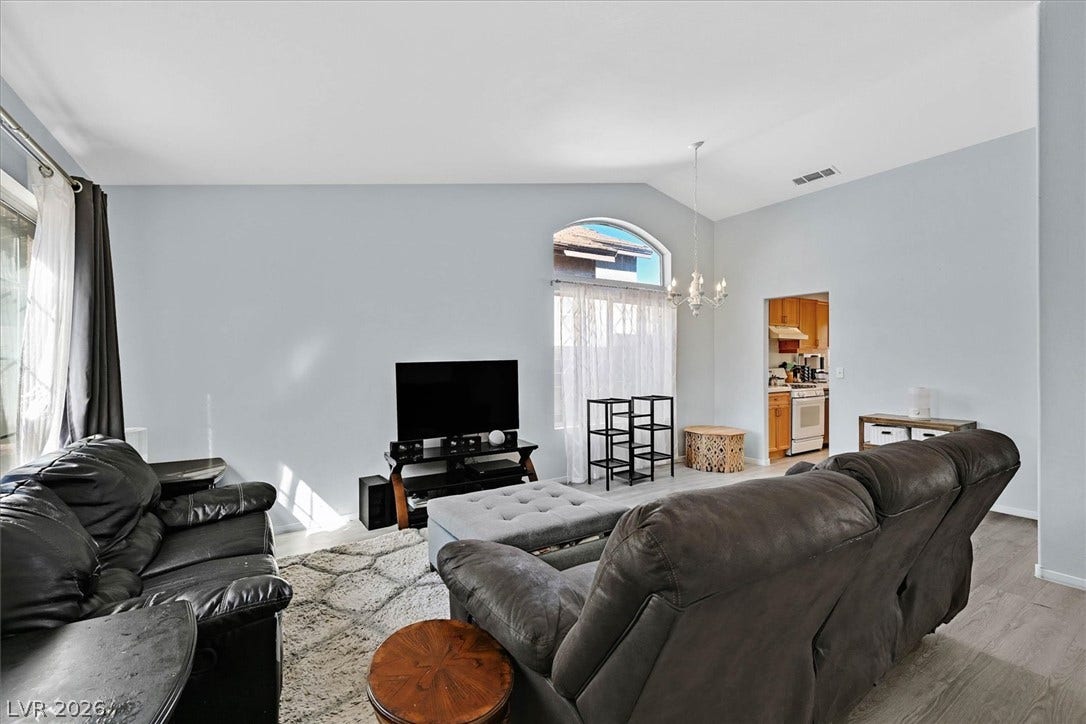 8830 Haviland Road, Las Vegas, NV 89123 High ceilings and an arched window define this open living area with wood floors.