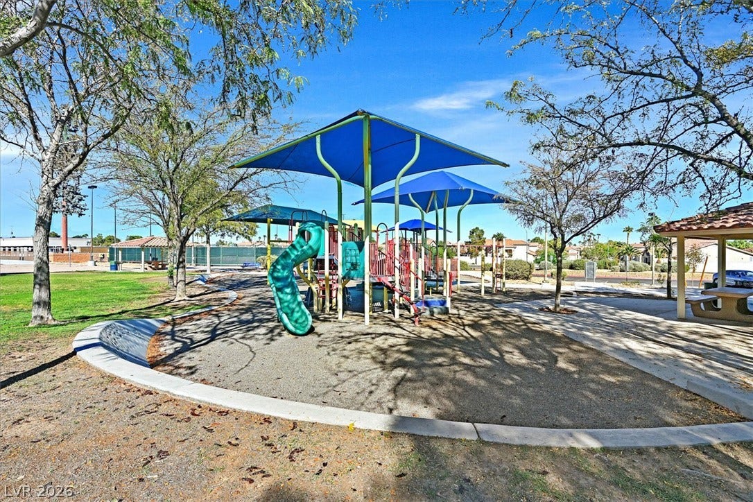 8830 Haviland Road, Las Vegas, NV 89123 A well-maintained neighborhood playground sits nestled beneath mature shade trees and clear blue skies.