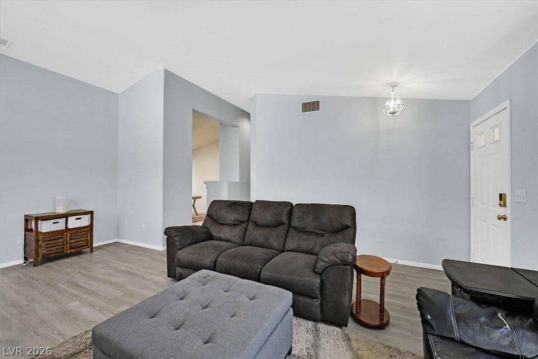 8830 Haviland Road, Las Vegas, NV 89123 High ceilings and durable wood-look flooring enhance this welcoming living space.