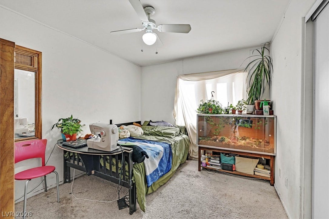 8830 Haviland Road, Las Vegas, NV 89123 Soft carpet flooring and natural light through a wide window define this cozy bedroom space.